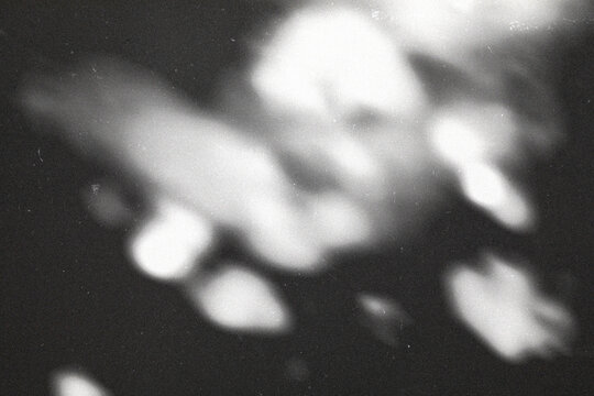 retro film overlay effect with scratch dust and blue light , retro grain noisy film distressed texture light leak flare on black background,black and white abstract light background,motion blur lights - Powered by Adobe