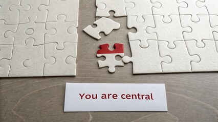 A red puzzle piece is the central focus of assembled pieces