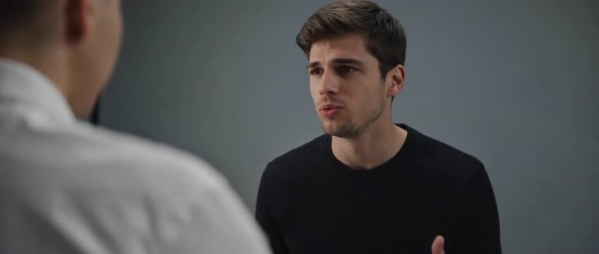 Focused Discussion: A candid moment unfolds as two individuals engage in a deep and focused discussion, their expressions conveying mutual interest and thoughtful exchange. 