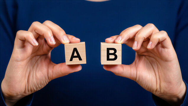 A/B Testing Concept: Hands Holding Wooden Blocks A and B for Business Analysis, Marketing Strategy, Comparison & Decision Making