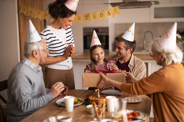 Family Celebrating a Birthday with a Gift and Decorations