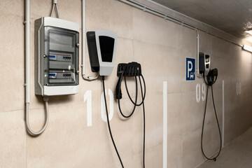 EV Charger Station and Electricity Meter for EV Charging for Personal Apartment in Urban Underground Car Parking Basement of Smart Apartment Building.