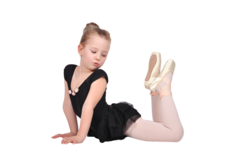 Young girl in ballet pose wearing black tutu and tights.