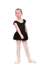 A little ballerina girl stands on the dance floor and is disappointed