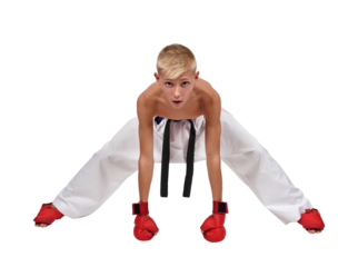 Young boy in white kimono with brown belt and red gloves showing kata posture
