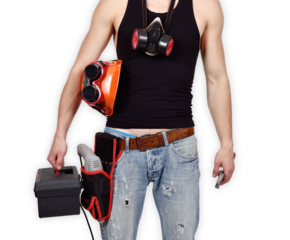 A mechanical engineer stands with orange helmet, drill, wrench and toolbox.