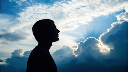 A person stands outdoors during sunset, looking up at the sky filled with clouds. The scene captures a moment of mindfulness and self-reflection, promoting mental health and well-being