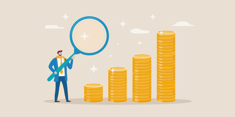 A man examining growing gold coin stacks with a magnifying glass