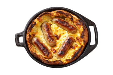 top view of traditional English toad in the hole with sausages and cheese, in a cast iron pan, isolated on a white background