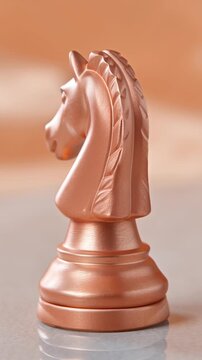 Brushed rose gold chess knight, reflective surface, peach fuzz gradient. Symbolize strategic business moves with a minimalist rose gold chess knight.