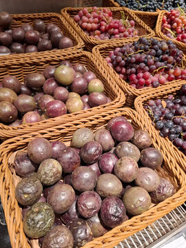 Passion fruits or marakuya and grapes at grocery store