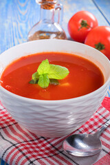 Tomato soup on wooden table.