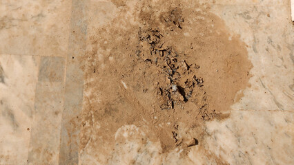 dried mud patch on marble floor surface