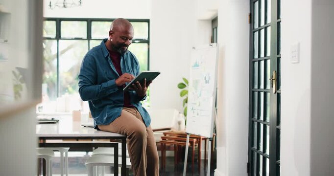 Creative, black man and typing on tablet in office for research, proofreading and update draft. Mature person, digital and editor feedback on article, story submission and information for publication