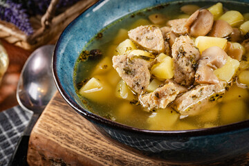Pure sour rye soup with white sausage, potatoes and mushrooms.