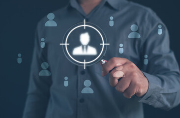 person holding a magnifying glass focusing on target user icon, representing customer targeting, audience analysis, recruitment selection, and data-driven strategies for identifying ideal candidates.