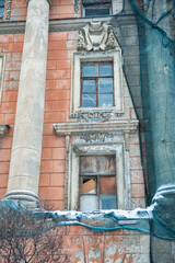 Naklejka premium Vintage architecture with weathered window and classical ornament