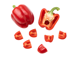 Whole and sliced red bell peppers on a black background