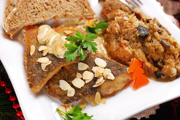 Fried carp  fillets with sauerkraut and bread for Christmas Eve supper