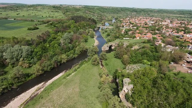 Spring drone video of the Rock Arch &ldquo;The Arch&rdquo; near Ăglen, showing the Slona rock formation, lush greenery, the karst landscape, and the winding Vit River, 2019