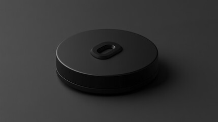 Matte black circular object with a recessed letter 'O'