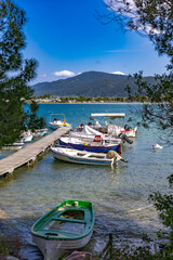 Small fishing boats at wooden pier in Fteroti, Sithonia, Chalkidiki, Greece