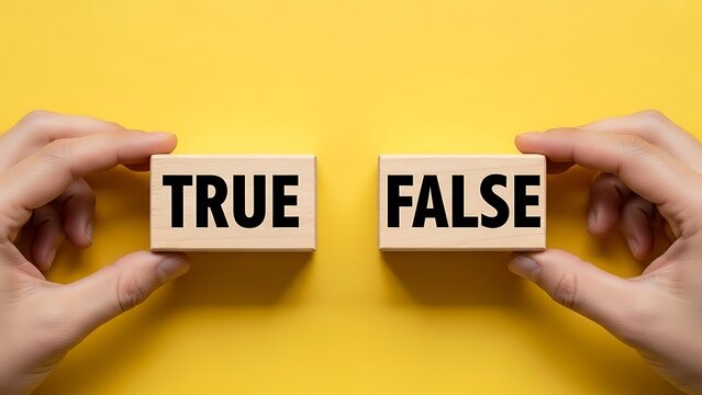 Hands hold true and false wooden blocks against a bright yellow background