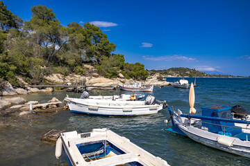 Small fishing boats at wooden pier in Fteroti, Sithonia, Chalkidiki, Greece