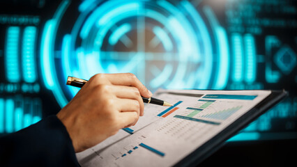A business professional woman hands reviews data on clipboard while holding pen, standing before futuristic digital interface with glowing blue analytics, emphasizing technology-driven analysis.