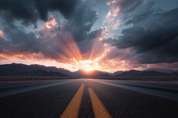 Asphalt road stretches towards horizon under dramatic sunset clouds