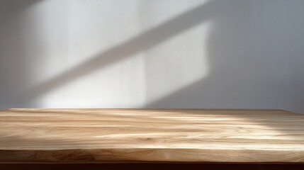 Close-up of a minimalist solid wood table, tabletop detail, with light and shadow on the wall, simple and elegant, a layout without foreground furniture in modern decor or design.