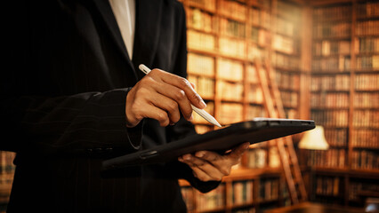 Professional woman holding digital tablet inside library, representing information management, cataloging, evolving responsibilities of modern librarians in physical, digital knowledge environments.