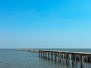 A coastal seascape with a concrete  with walkway by  the sea