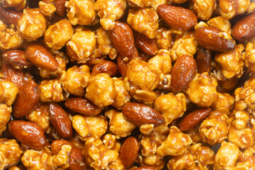 Top view of caramel popcorn with almonds for background