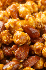 Pile of caramel popcorn with almonds rotating for background. Close-up