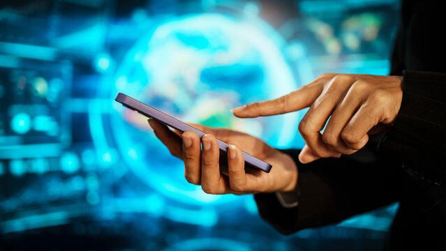 Business woman holding smartphone in front of futuristic digital interface, global communication, technology networking, data connectivity, mobile interaction, high-tech environment. - Powered by Adobe