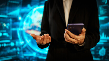 Business woman holding smartphone in front of futuristic digital interface, global communication, technology networking, data connectivity, mobile interaction, high-tech environment.