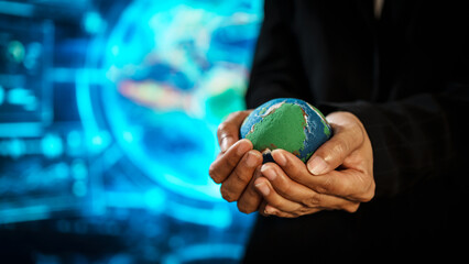 Business professional holding small Earth model before futuristic digital interface, global responsibility,environmental awareness,world protection, sustainability, modern international collaboration