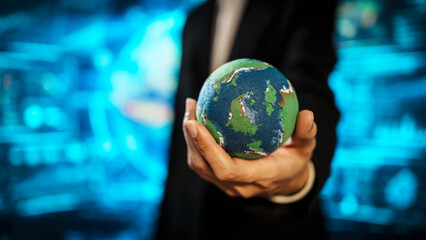 Business professional holding small Earth model before futuristic digital interface, global responsibility,environmental awareness,world protection, sustainability, modern international collaboration