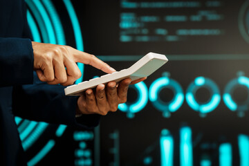 Business professional using digital tablet before futuristic radar-style interface, technology interaction, data processing, cyber analytics, innovation, modern workflow, advanced digital operations