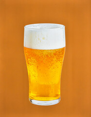 Cold Beer with Foam in Transparent Glass Isolated on Brown Background for Alcohol Beverage Object and Pub Drink Concept