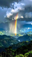 Colorful rainbow shining brightly over lush green mountains under dramatic, cloudy sky, and rain