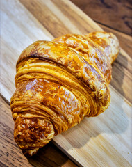 French Croissant Pastry with Flaky Layers Served on Wooden Plate for Premium Bakery Object and Gourmet Breakfast Concept