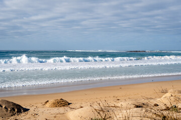 Sandy beach along the Great Ocean Road, Australia under cloudy sky