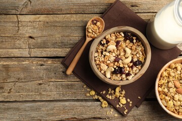 Tasty granola with dried fruits, nuts and milk on wooden table, flat lay. Space for text