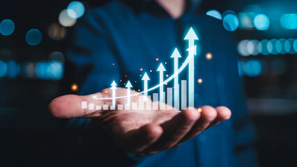 Dynamic businessman holds glowing upward trending bar chart showing incredible financial growth and success in modern night setting