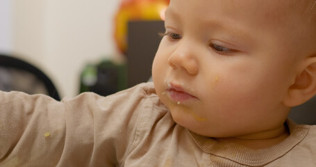 A cheerful little boy is discovering the joys of healthy eating as he enjoys a nutritious snack. His joy is evident as he tastes different flavors with excitement and curiosity.