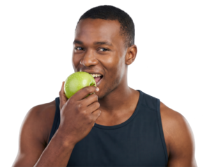Healthy African American man biting into a crisp green fruit against a clean white background, promoting wellness and a healthy lifestyle. Focused