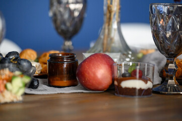Close up of apple grapes appetizer desserts on blue wall background.