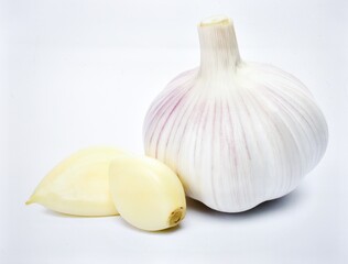 Whole garlic bulb with peeled cloves isolated on white background, organic seasoning and natural cooking ingredient concept